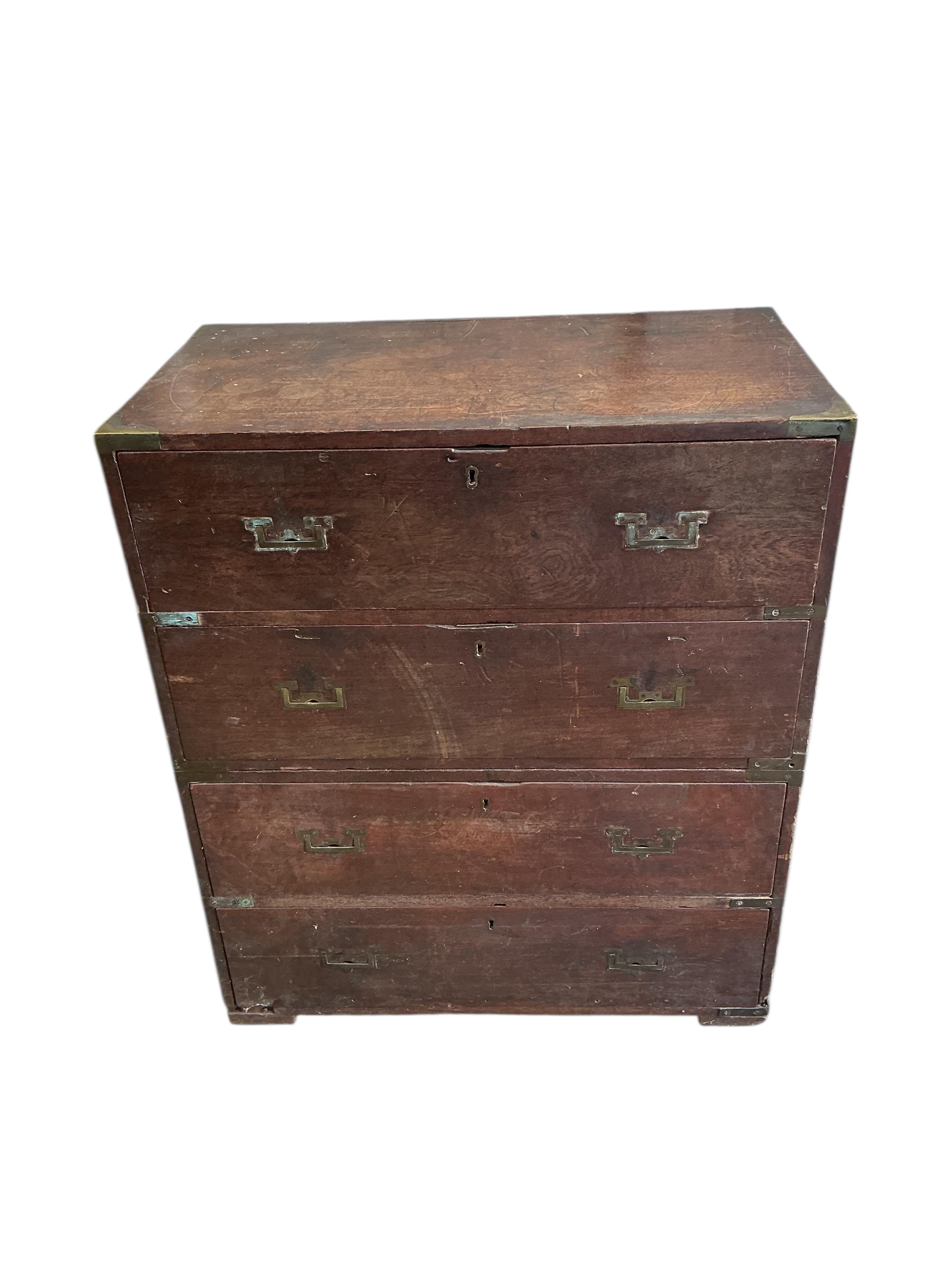 A small early 19th century teak two part campaign chest, the back with stencilled name, Mrs Nepean, width 81cm, depth 46cm, height 95cm